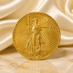 1927 Saint-Gaudens Double Eagle gold coin displayed on luxury ivory fabric and polished marble